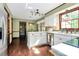 Updated kitchen with a view of dining area featuring a table and large windows at 7020 Leesburg Rd, Charlotte, NC 28215