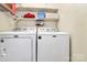 Functional laundry room with a white washer and dryer at 7020 Leesburg Rd, Charlotte, NC 28215