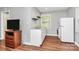 Spacious living area including modern appliances, laundry, and wooden floors at 7020 Leesburg Rd, Charlotte, NC 28215