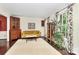 Bright living room with hardwood floors, a yellow sofa, and large windows at 7020 Leesburg Rd, Charlotte, NC 28215