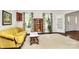 Spacious living room featuring hardwood floors, a yellow sofa, and natural light at 7020 Leesburg Rd, Charlotte, NC 28215