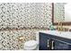 Charming powder room featuring a unique wallpaper design and updated vanity at 7020 Leesburg Rd, Charlotte, NC 28215