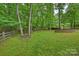 Spacious backyard features a custom stone firepit and lush landscaping at 7067 Rocky Falls Rd, Charlotte, NC 28211