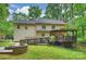 View of the home's backyard featuring a deck, patio, ramp, and beautifully landscaped yard at 7067 Rocky Falls Rd, Charlotte, NC 28211