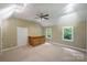Large bonus room featuring a wooden bar and two windows at 7067 Rocky Falls Rd, Charlotte, NC 28211