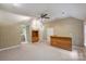 Large bonus room with beige carpet, wood bar, storage cabinets, and ample space for entertainment at 7067 Rocky Falls Rd, Charlotte, NC 28211