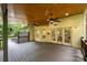 Large covered deck perfect for outdoor relaxation, with wood flooring, ceiling fans, and access to the house at 7067 Rocky Falls Rd, Charlotte, NC 28211