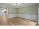 Spacious dining room with hardwood floors, detailed wainscoting, and a modern chandelier, perfect for entertaining at 7067 Rocky Falls Rd, Charlotte, NC 28211