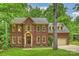 Charming two-story brick home with a well-manicured lawn and mature trees at 7067 Rocky Falls Rd, Charlotte, NC 28211