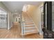 Bright foyer with hardwood floors and staircase leading to the second floor at 7067 Rocky Falls Rd, Charlotte, NC 28211