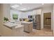 Bright kitchen with white cabinets, stainless appliances, tile floors and skylights at 7067 Rocky Falls Rd, Charlotte, NC 28211