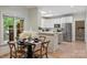 Bright kitchen and breakfast nook with white cabinets, stainless appliances and outdoor view at 7067 Rocky Falls Rd, Charlotte, NC 28211