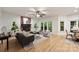Bright living room featuring a brick fireplace, ceiling fan and lots of natural light at 7067 Rocky Falls Rd, Charlotte, NC 28211