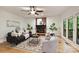 Living room with fireplace, ceiling fan, hardwood floors and patio doors at 7067 Rocky Falls Rd, Charlotte, NC 28211