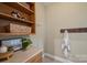Mud room featuring built-in shelves, hooks, and a convenient countertop space at 7067 Rocky Falls Rd, Charlotte, NC 28211