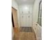 Bright mudroom with built-in cabinets, tiled floor and modern rug accents, providing stylish storage near the entrance at 7067 Rocky Falls Rd, Charlotte, NC 28211