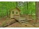 Charming outbuilding nestled amongst trees with a deck and beautiful natural surroundings at 7067 Rocky Falls Rd, Charlotte, NC 28211