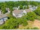 Aerial view showcasing a home with a spacious backyard, mature trees, and white picket fence at 709 Circle Trace Rd, Monroe, NC 28110