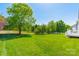 Picturesque backyard with lush green lawn, mature trees, and well-maintained landscaping at 709 Circle Trace Rd, Monroe, NC 28110