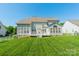 Expansive backyard featuring a well-maintained lawn and a back porch with access to the house at 709 Circle Trace Rd, Monroe, NC 28110