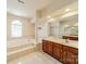 Bright primary bathroom with a large soaking tub, dual vanities, and a separate shower at 709 Circle Trace Rd, Monroe, NC 28110