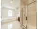 Bright bathroom featuring a soaking tub, a window, and a separate glass shower at 709 Circle Trace Rd, Monroe, NC 28110