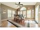 A dining room features a ceiling fan, a large arched window, and views of the well-lit backyard at 709 Circle Trace Rd, Monroe, NC 28110