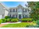 Beautiful two-story gray brick home featuring manicured landscaping, a front lawn, and a welcoming entrance at 709 Circle Trace Rd, Monroe, NC 28110