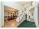 Grand foyer featuring a staircase with wooden handrails and a view into the dining room at 709 Circle Trace Rd, Monroe, NC 28110
