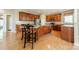 An open kitchen features wood cabinetry, a stainless steel refrigerator and a central island with seating at 709 Circle Trace Rd, Monroe, NC 28110