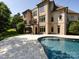 Luxury backyard features a beautiful in-ground pool, spiral staircase, and manicured landscaping at 7409 Stonecroft Park Dr, Charlotte, NC 28226