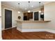 Basement wet bar with hardwood floors and pendant lighting at 7409 Stonecroft Park Dr, Charlotte, NC 28226