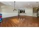Open basement with hardwood floors and partial kitchen view at 7409 Stonecroft Park Dr, Charlotte, NC 28226