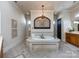 Luxurious bathroom showcasing a large soaking tub, decorative lighting and custom tile surround at 7409 Stonecroft Park Dr, Charlotte, NC 28226