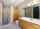 Bright bathroom featuring a shower, toilet, and vanity with wooden cabinets at 7409 Stonecroft Park Dr, Charlotte, NC 28226