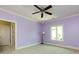 Comfortable bedroom featuring lavender walls, carpet, and a large window bringing in natural light at 7409 Stonecroft Park Dr, Charlotte, NC 28226