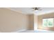 Neutral bedroom with ceiling fan, window and light carpet at 7409 Stonecroft Park Dr, Charlotte, NC 28226