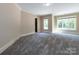 Spacious bonus room featuring plush gray carpeting and abundant natural light from large windows at 7409 Stonecroft Park Dr, Charlotte, NC 28226