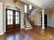 Grand foyer featuring hardwood floors, a staircase with iron railings, and an arched doorway at 7409 Stonecroft Park Dr, Charlotte, NC 28226
