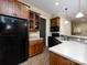 Kitchen with wood cabinets, black appliances, and tile flooring at 7409 Stonecroft Park Dr, Charlotte, NC 28226