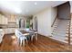 Open-concept kitchen and dining area with hardwood floors and staircase at 7409 Stonecroft Park Dr, Charlotte, NC 28226