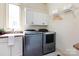 Well-lit laundry room featuring a modern washer and dryer, sink, and storage cabinets at 7409 Stonecroft Park Dr, Charlotte, NC 28226