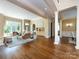 Spacious living room with hardwood floors, columns, and a large window offering natural light at 7409 Stonecroft Park Dr, Charlotte, NC 28226