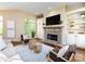 Inviting living room with fireplace, built-in shelves, and plenty of natural light at 7409 Stonecroft Park Dr, Charlotte, NC 28226