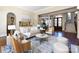 Bright living room with neutral decor, hardwood floors, and a view of the dining area and staircase at 7409 Stonecroft Park Dr, Charlotte, NC 28226