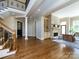 Open-concept living area showcasing hardwood floors, columns, and a view of the staircase at 7409 Stonecroft Park Dr, Charlotte, NC 28226