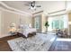 Bright main bedroom boasts large windows, tray ceiling, and a stylish rug at 7409 Stonecroft Park Dr, Charlotte, NC 28226