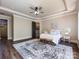Inviting main bedroom with a trey ceiling, hardwood flooring, large rug and access to the en suite at 7409 Stonecroft Park Dr, Charlotte, NC 28226