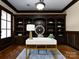 Beautiful office features custom built-ins and a modern white and gold desk with decor at 7409 Stonecroft Park Dr, Charlotte, NC 28226
