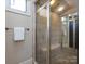Shower with glass door, bench seat and tile surround at 7409 Stonecroft Park Dr, Charlotte, NC 28226